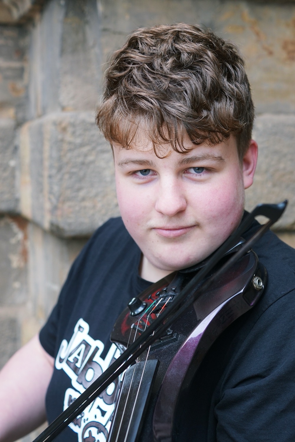 Barber 1 young man with beard smiling and wearing a  brown shirt